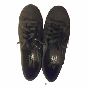 Brand new black Skechers sneakers.